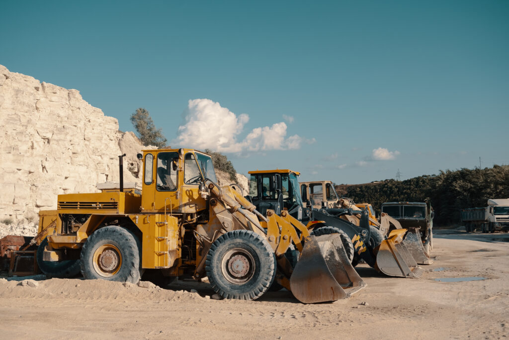 Large plant machinery rolling in barren land